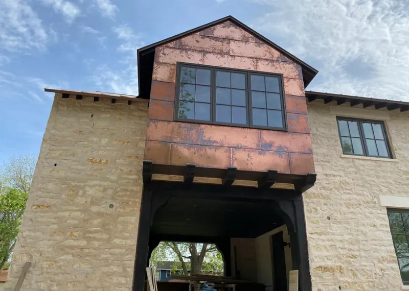 Copper metal panel facade on a stone building for Skylight Installation in Moore
