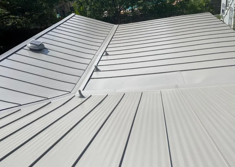 Solar attic fan installed on a metal roof for Roof Ventilation in Moore
